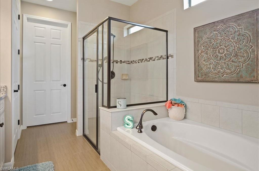 10809 Dennington Road Fort Myers, FL 33913 - Photo 16 of 30 a bathroom with a bathtub and a shower