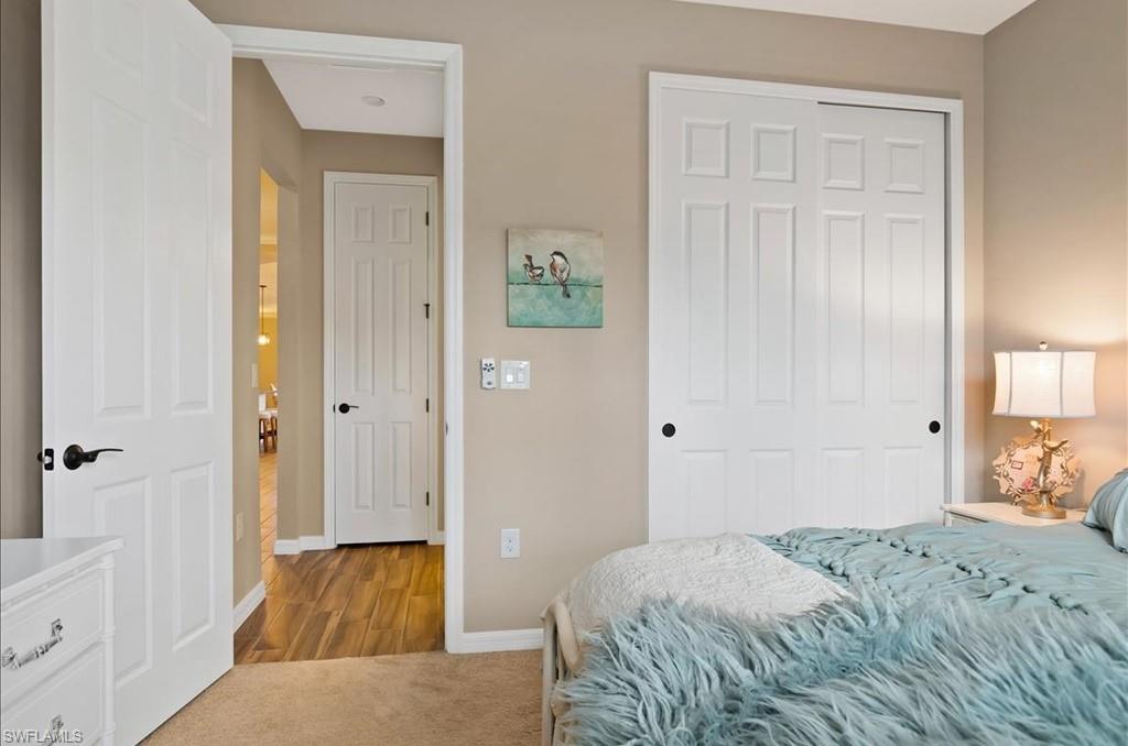 10809 Dennington Road Fort Myers, FL 33913 - Photo 19 of 30 a bedroom with a bed and hallway