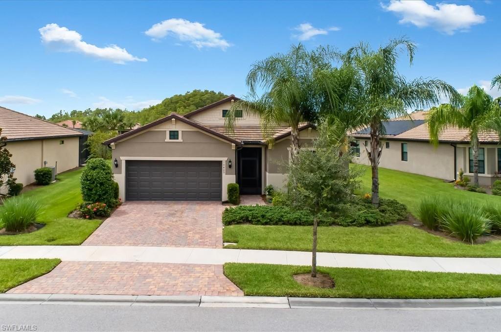 10809 Dennington Road Fort Myers, FL 33913 - Photo 2 of 30 a front view of a house with a garden and plants