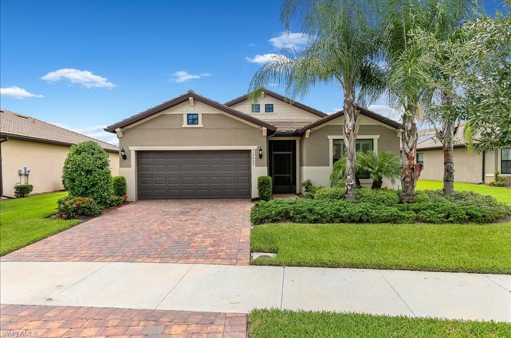 10809 Dennington Road Fort Myers, FL 33913 - Photo 23 of 30 a front view of a house with a yard and garage