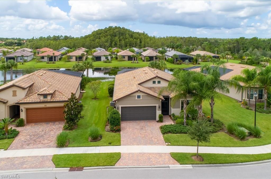 10809 Dennington Road Fort Myers, FL 33913 - Photo 26 of 30 an aerial view of multiple houses with a yard