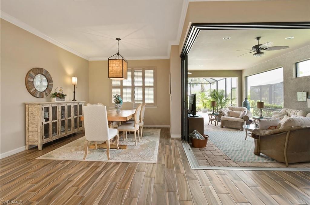 10809 Dennington Road Fort Myers, FL 33913 - Photo 5 of 30 a living room with furniture a fireplace and large windows