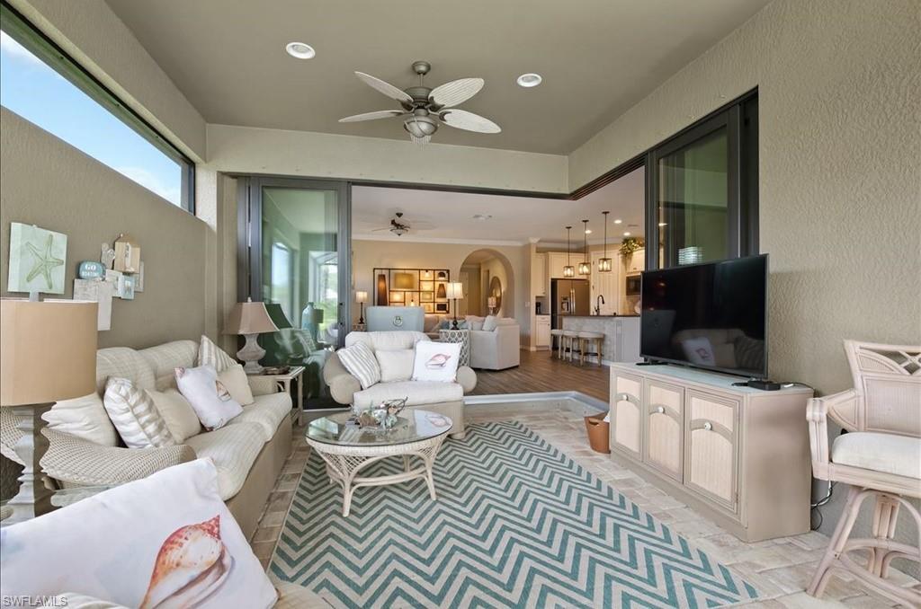 10809 Dennington Road Fort Myers, FL 33913 - Photo 10 of 30 a living room with furniture a flat screen tv and a chandelier