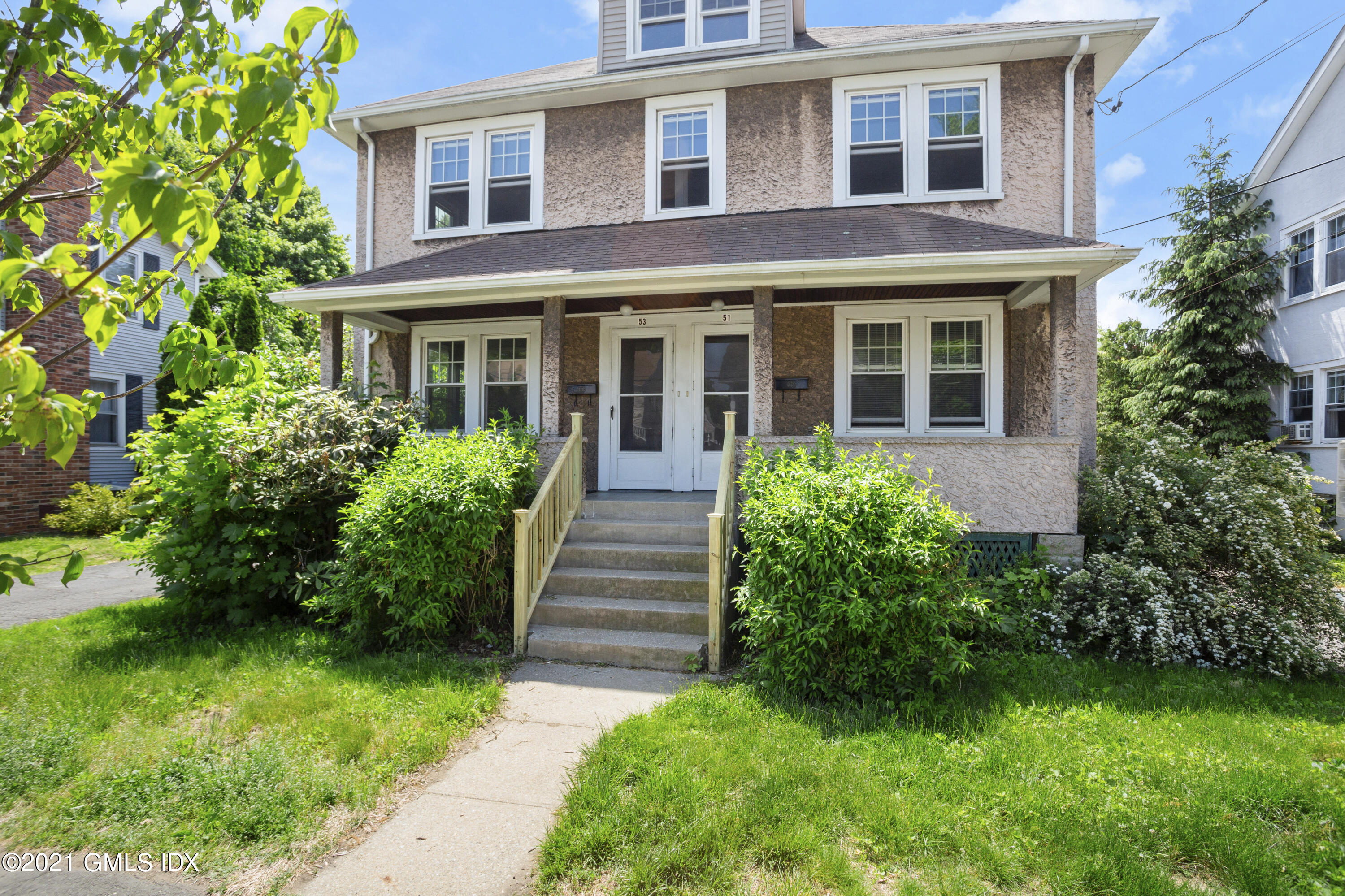 53 Richland Road Greenwich, CT 06830 - Photo 1 of 20 a view of a brick house with a yard plants and large tree