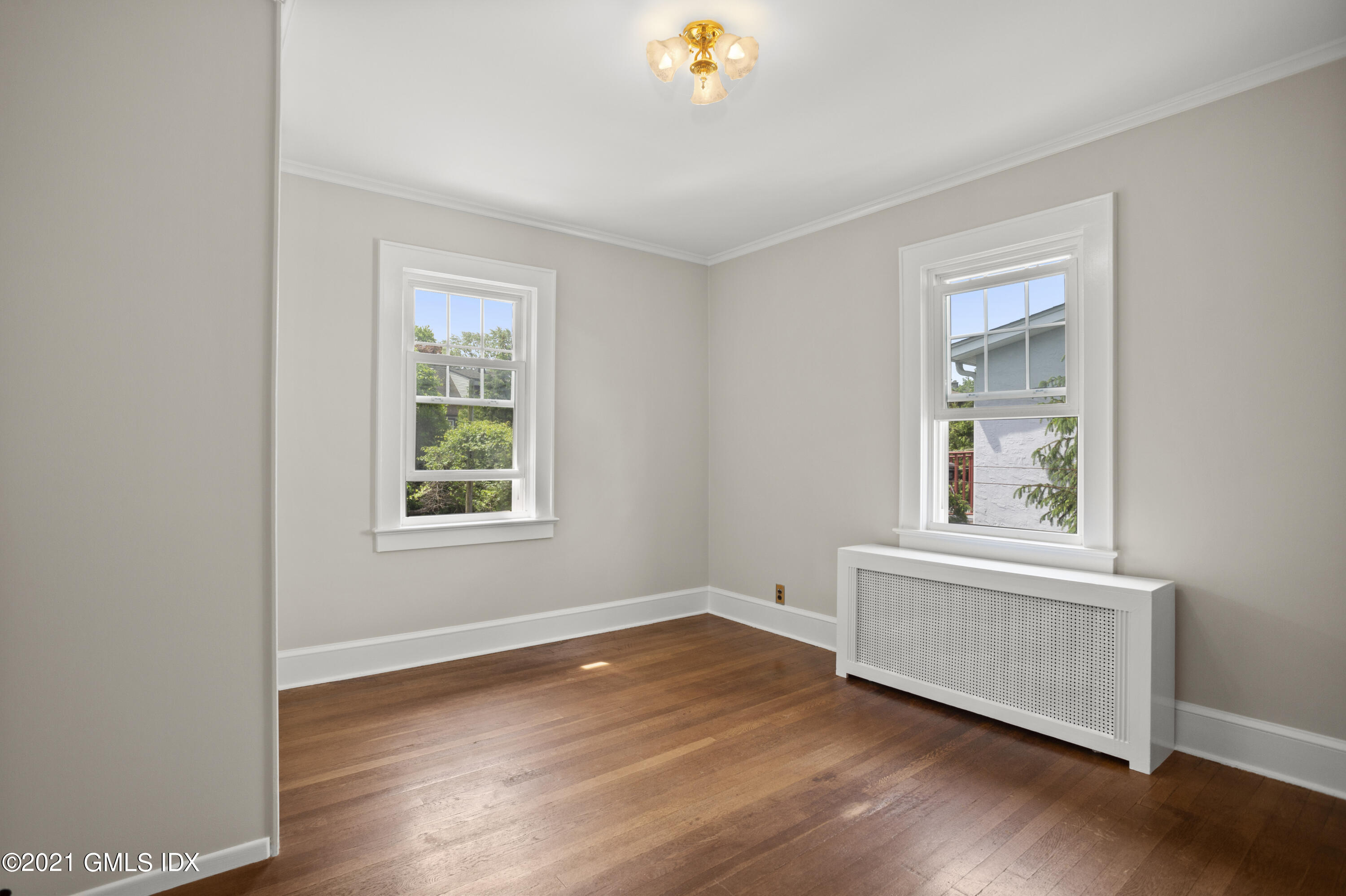 53 Richland Road Greenwich, CT 06830 - Photo 11 of 20 an empty room with wooden floor and windows