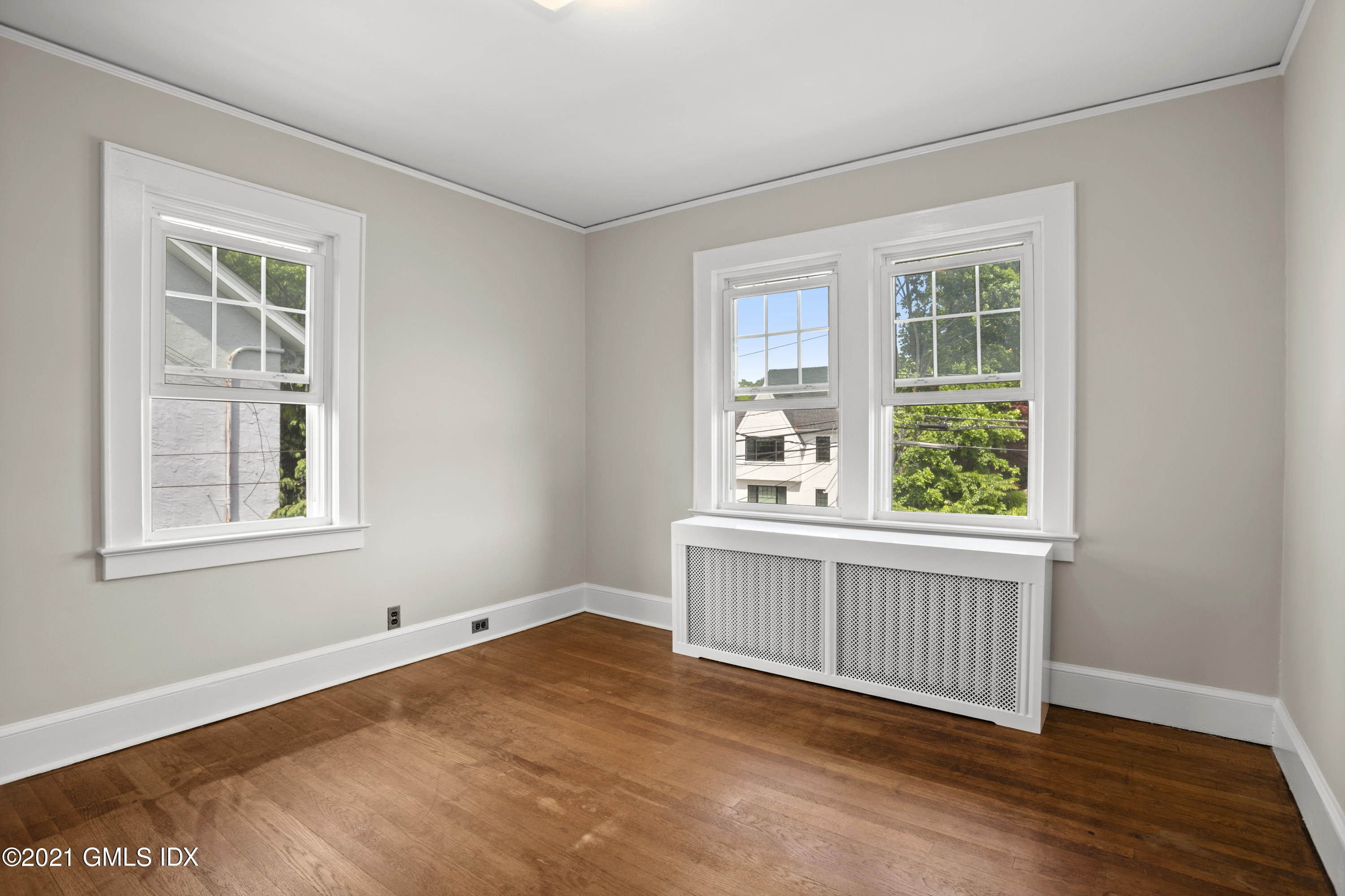 53 Richland Road Greenwich, CT 06830 - Photo 12 of 20 an empty room with wooden floor and windows