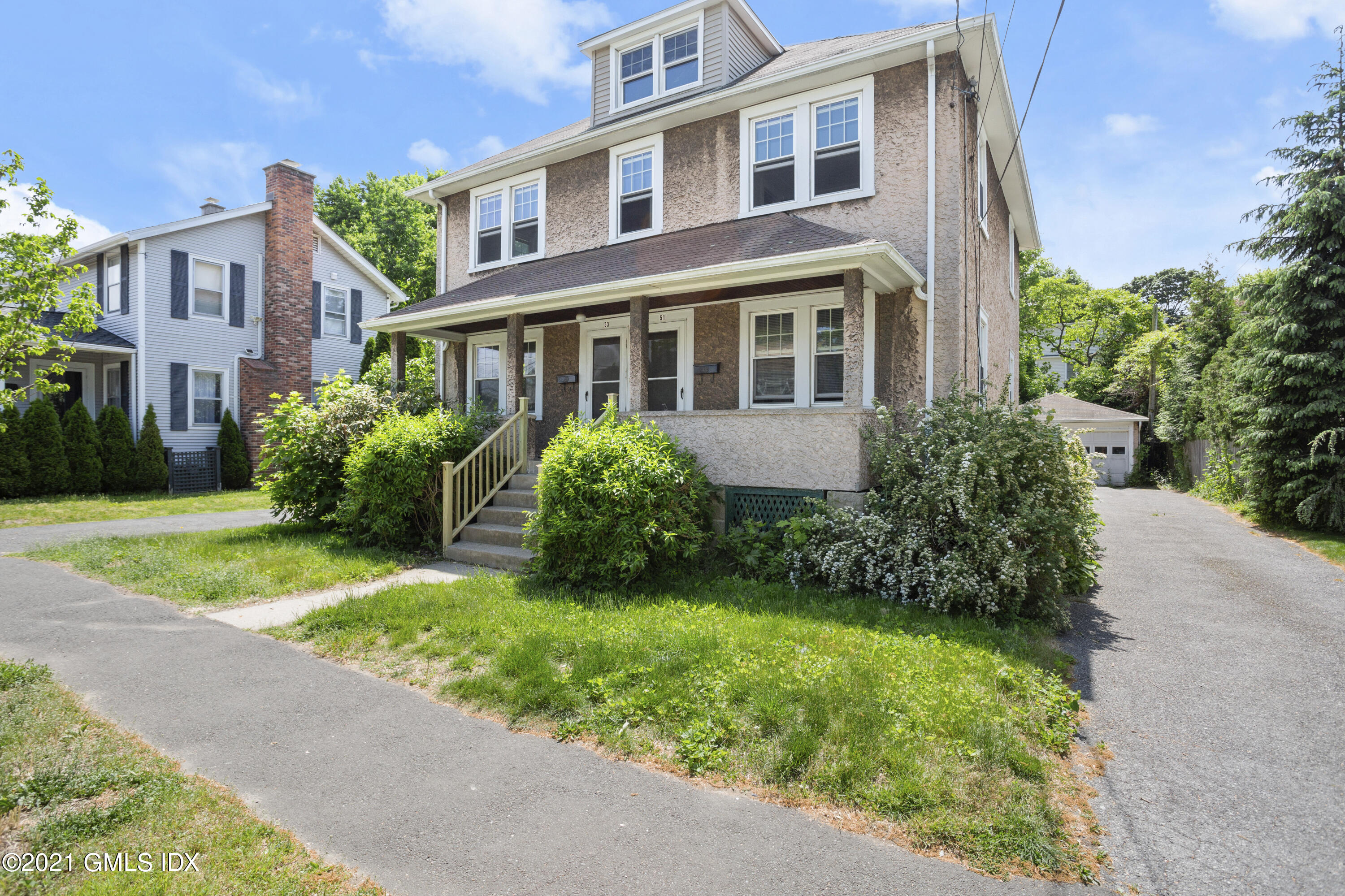 53 Richland Road Greenwich, CT 06830 - Photo 2 of 20 a front view of a house with garden and trees