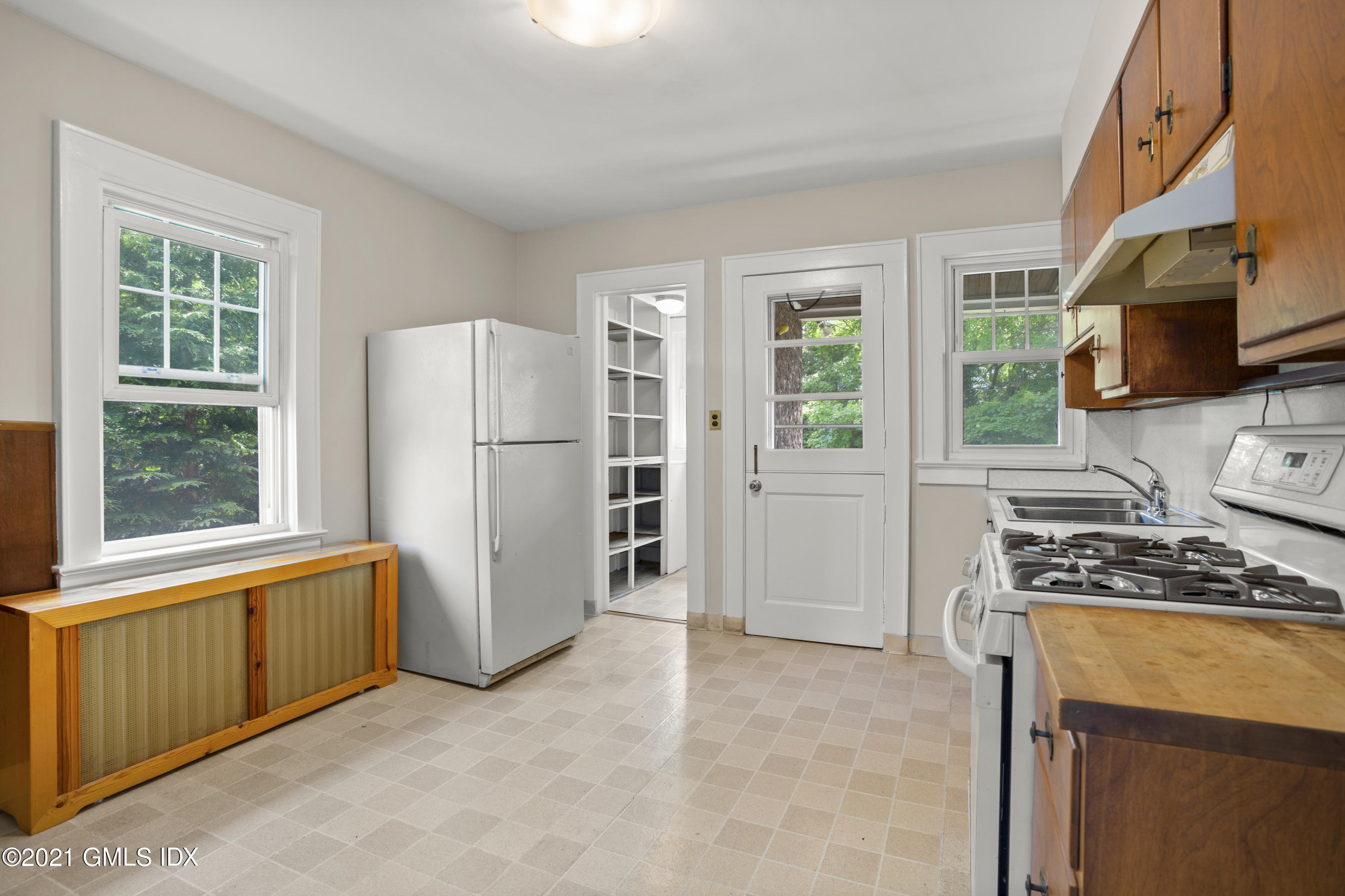53 Richland Road Greenwich, CT 06830 - Photo 7 of 20 a kitchen with stainless steel appliances granite countertop a refrigerator and a stove top oven