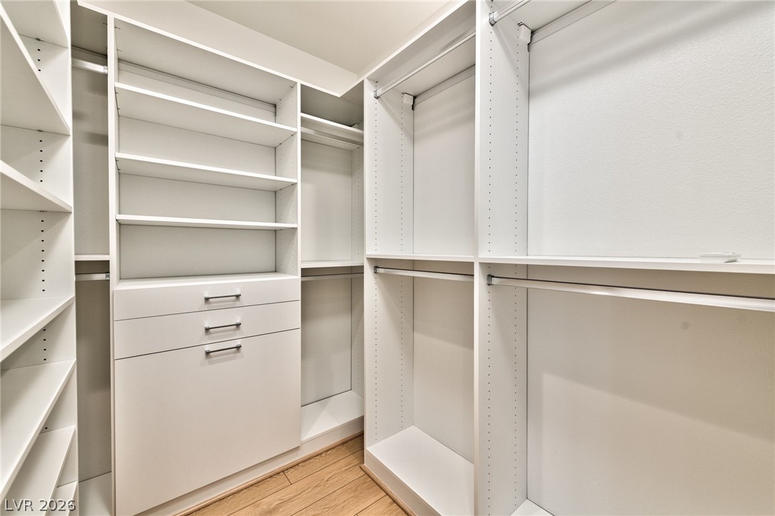 3327 Esker Rdg Avenue Henderson, NV 89044 - Photo 12 of 24 Well-organized custom shelving and hanging rods offer abundant storage in this primary closet.