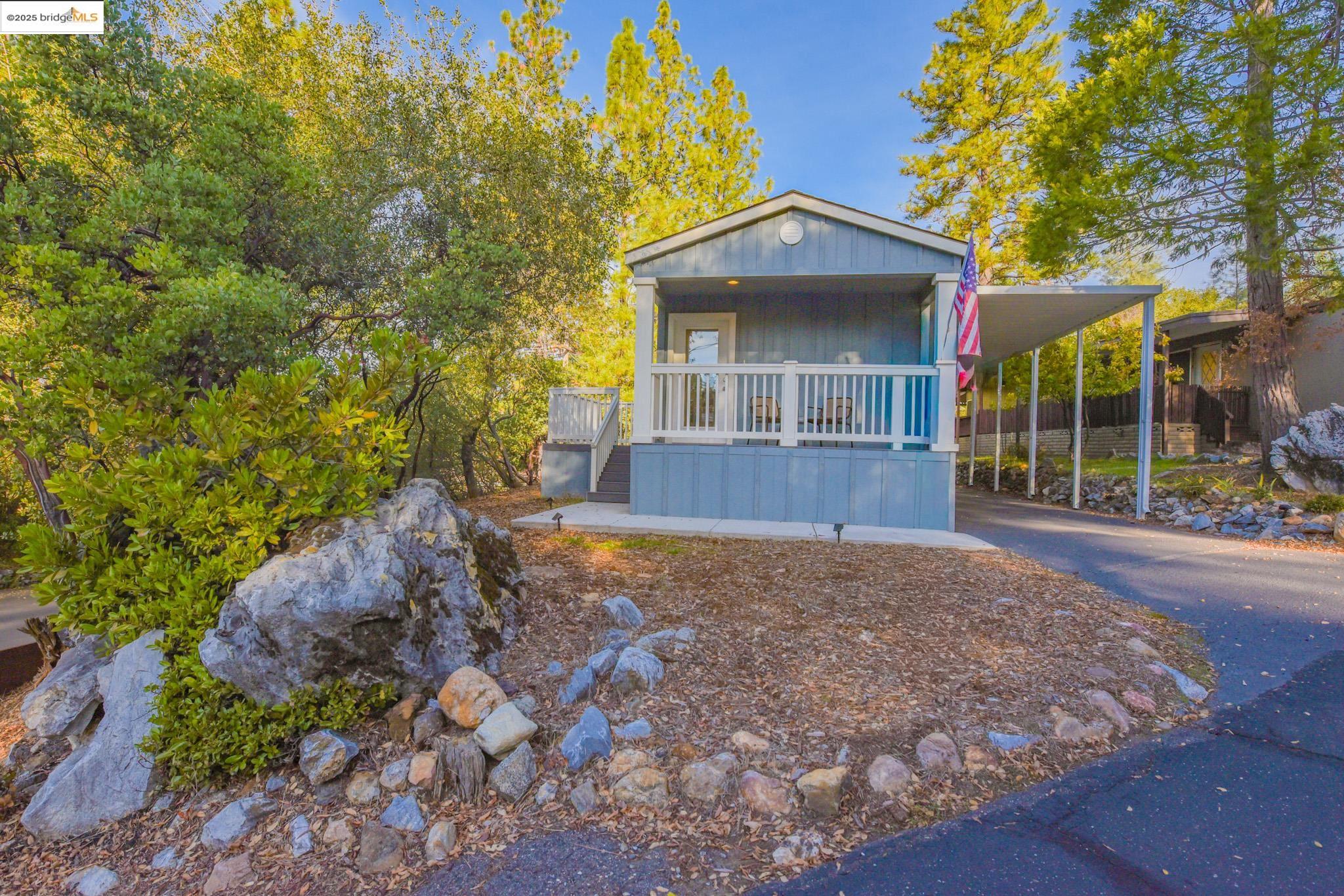 10956 Green Street Columbia, CA 95310 - Photo 37 of 45 View of front facade featuring asphalt driveway, an attached carport, and a porch