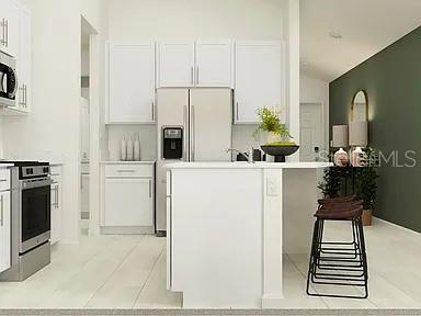 35008 Ackley Trace Zephyrhills, FL 33541 - Photo 5 of 11 a kitchen with stainless steel appliances a sink and a refrigerator