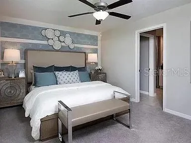 a bedroom with a bed and a chandelier