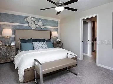 35008 Ackley Trace Zephyrhills, FL 33541 - Photo 8 of 11 a bedroom with a bed and a chandelier