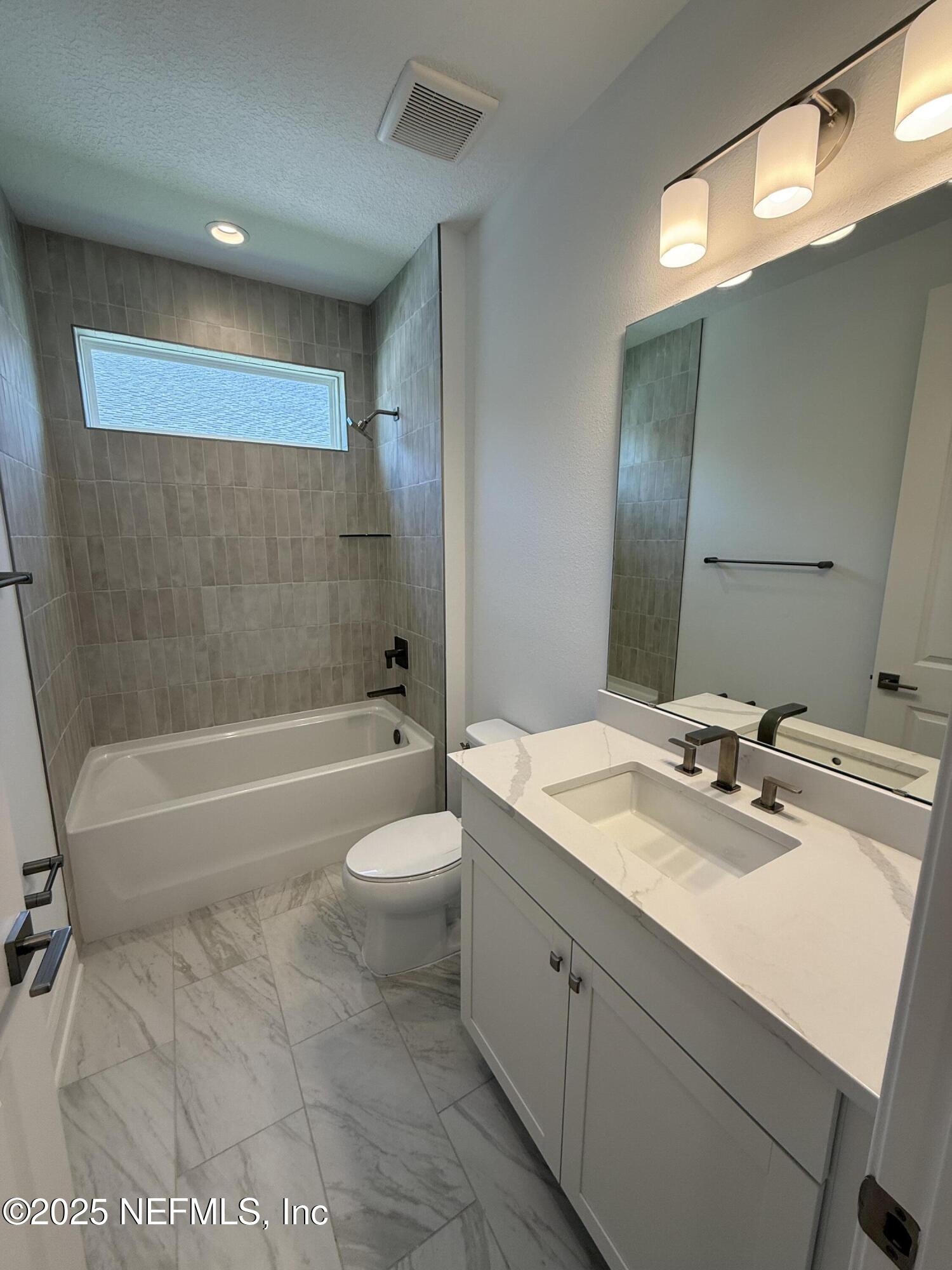 34 Mulberry Road Palm Coast, FL 32164 - Photo 12 of 63 a bathroom with a sink a toilet and bathtub