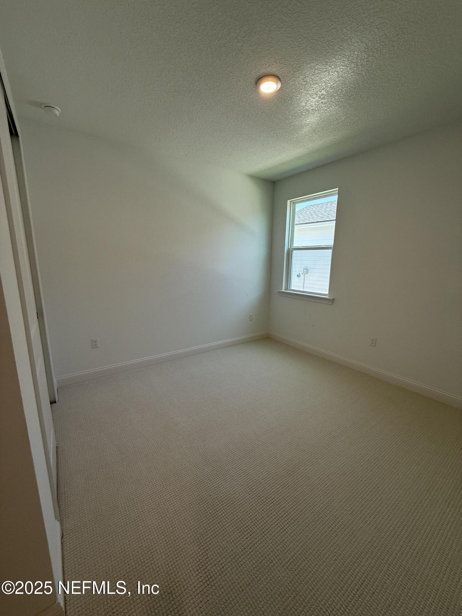 34 Mulberry Road Palm Coast, FL 32164 - Photo 15 of 63 an empty room with a window