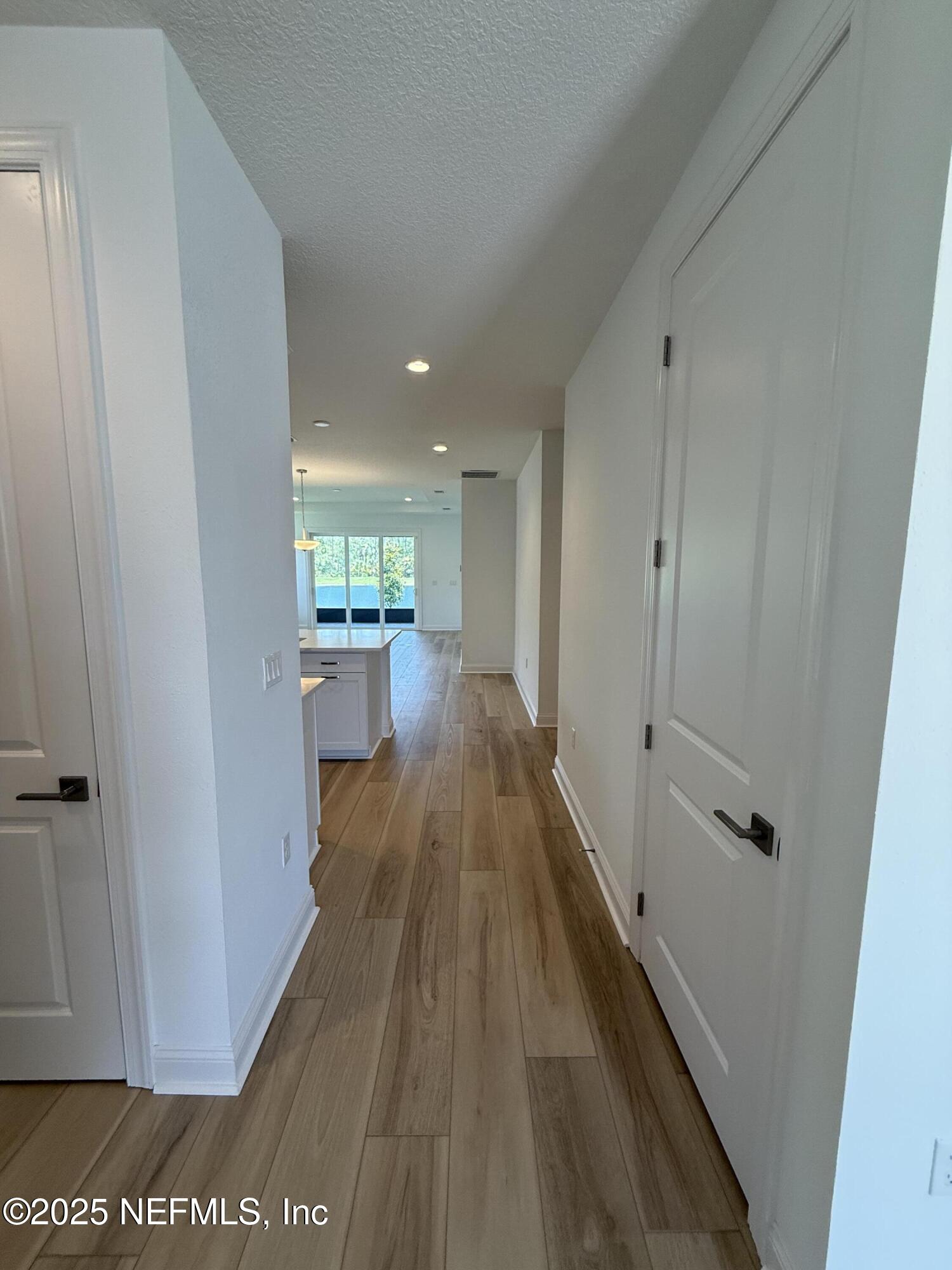 34 Mulberry Road Palm Coast, FL 32164 - Photo 18 of 63 a view of a hallway with wooden floor and staircase