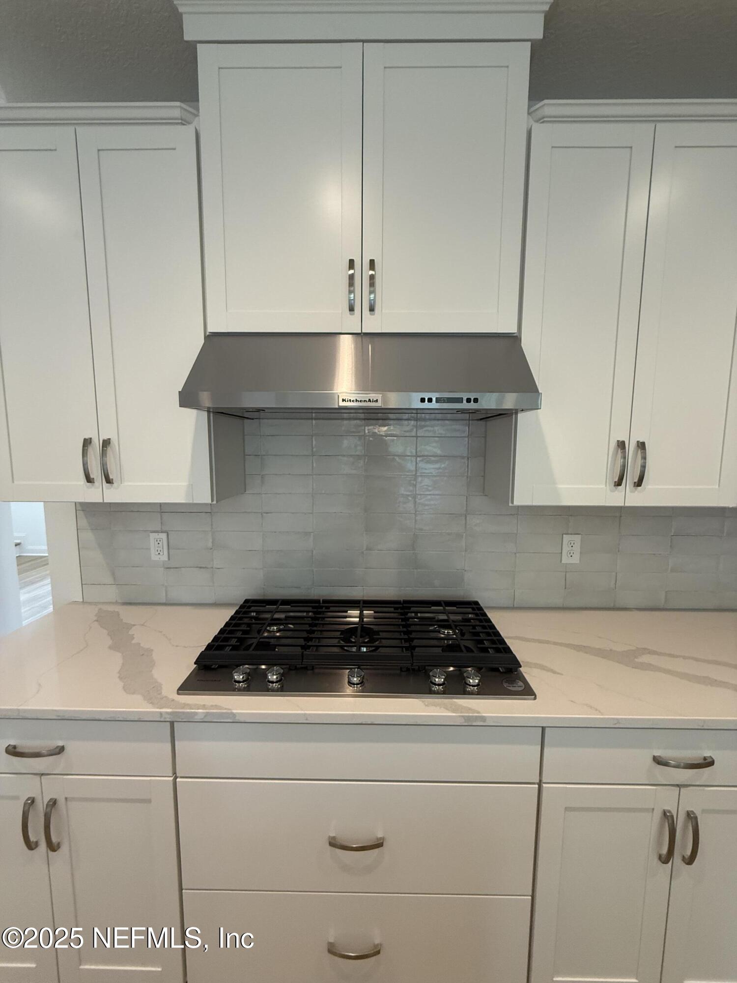 34 Mulberry Road Palm Coast, FL 32164 - Photo 21 of 63 a kitchen with a stove and cabinets