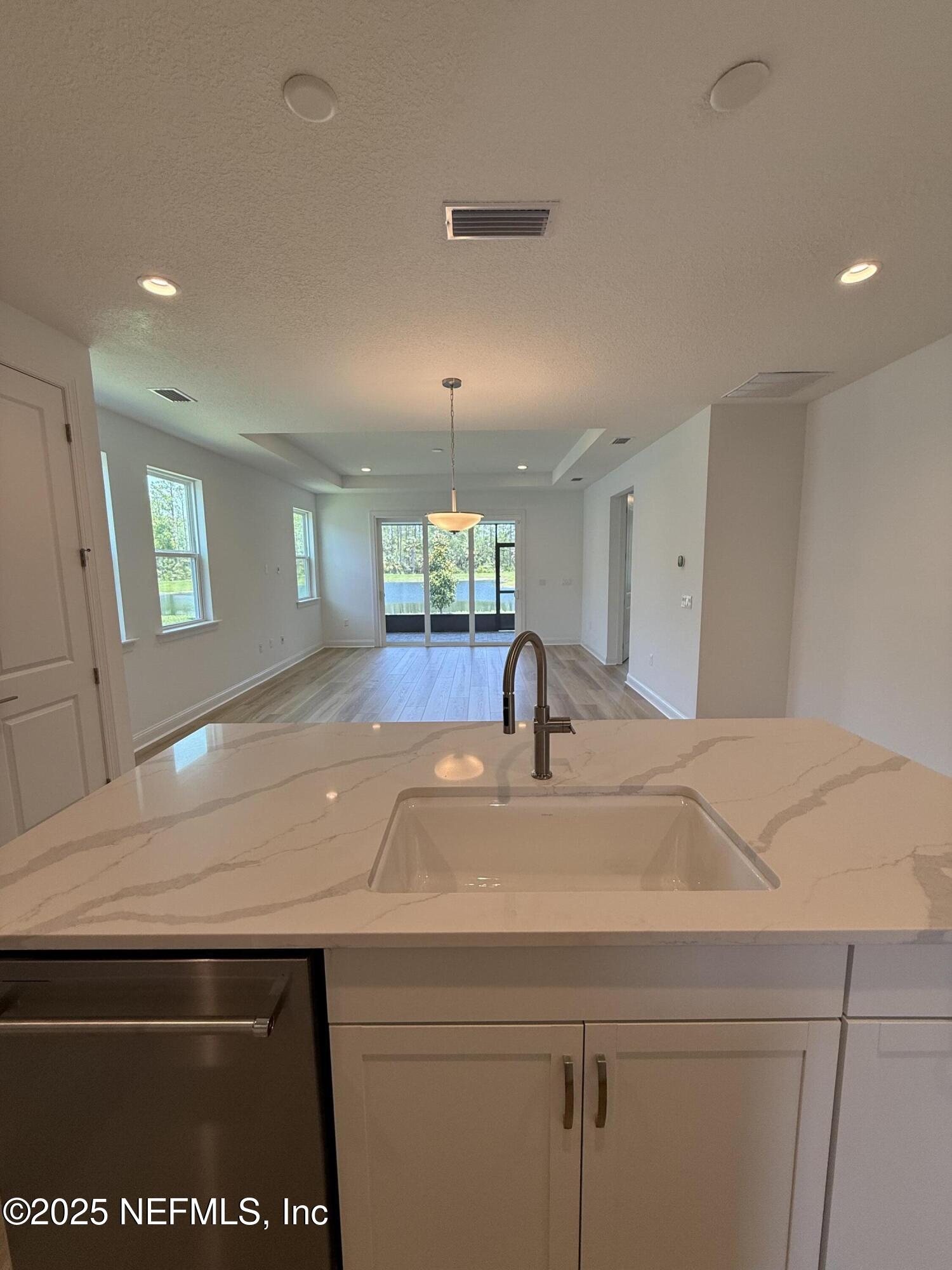 34 Mulberry Road Palm Coast, FL 32164 - Photo 24 of 63 a kitchen with a sink and a refrigerator