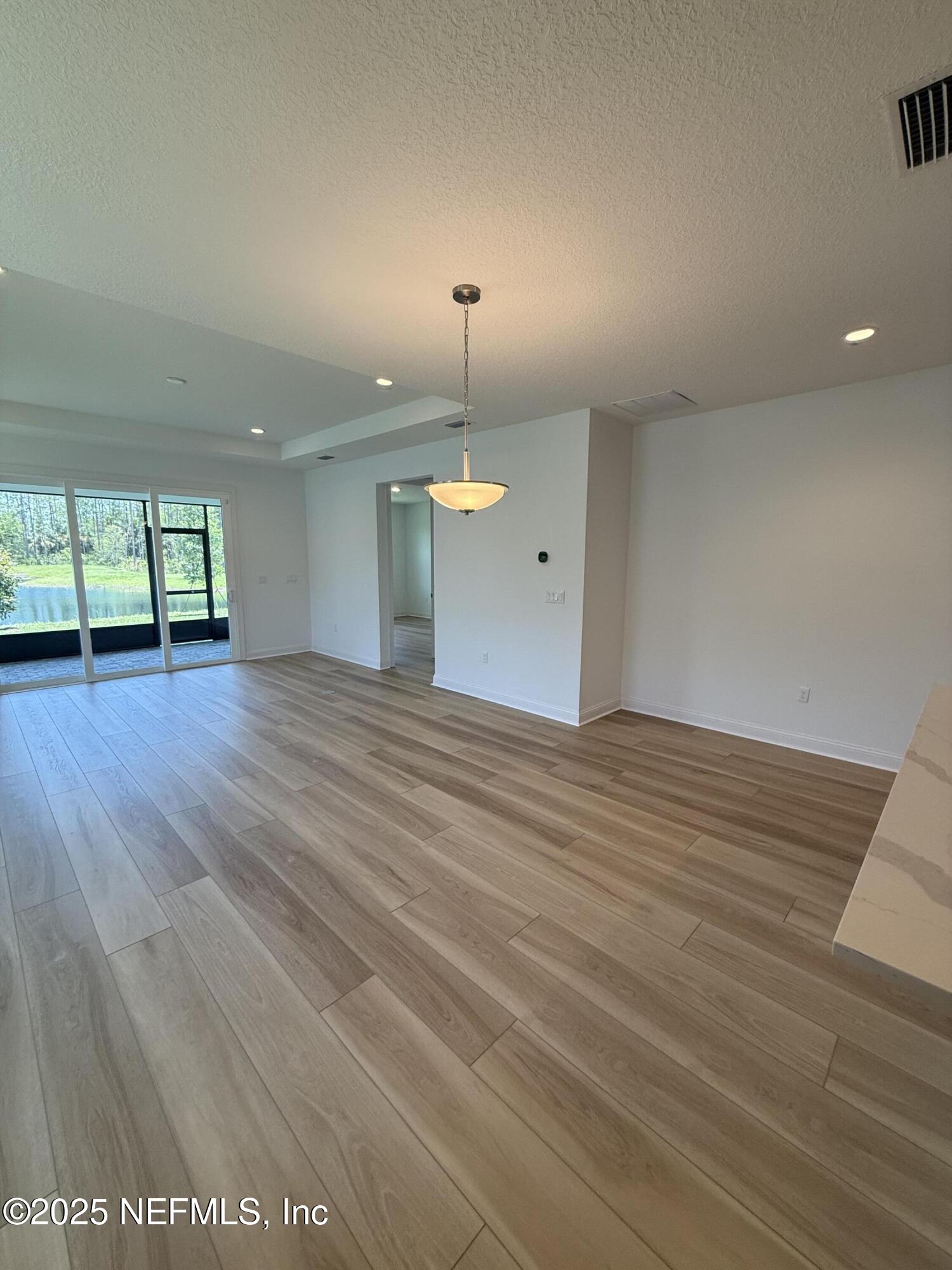 34 Mulberry Road Palm Coast, FL 32164 - Photo 30 of 63 a view of an empty room with window and wooden floor