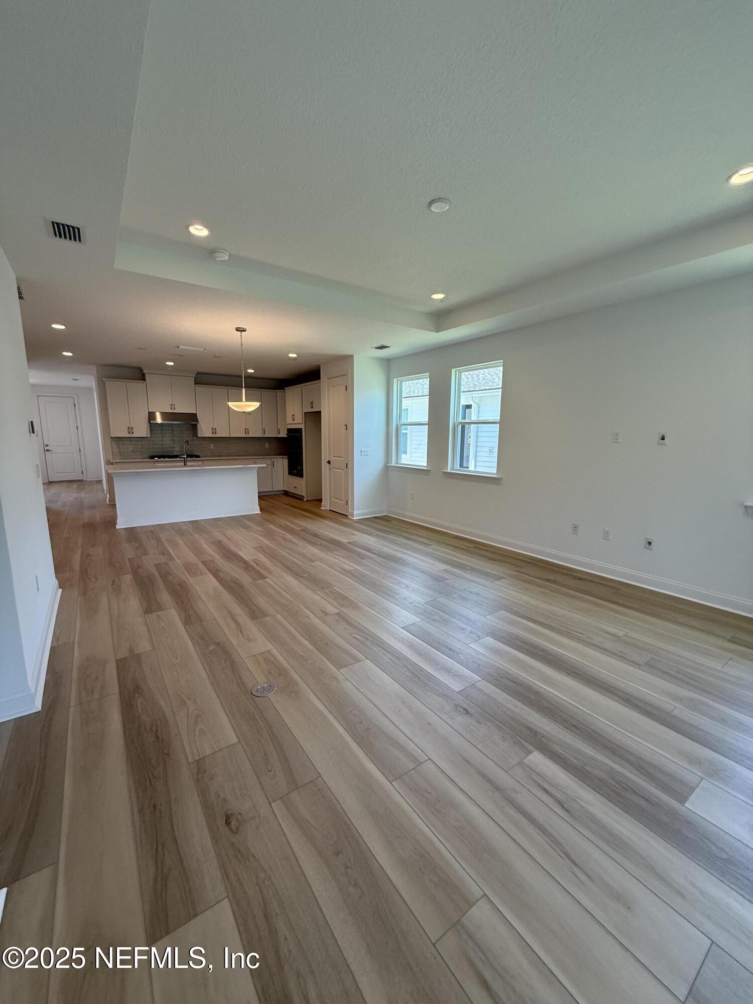 34 Mulberry Road Palm Coast, FL 32164 - Photo 32 of 63 an empty room with wooden floor and a window