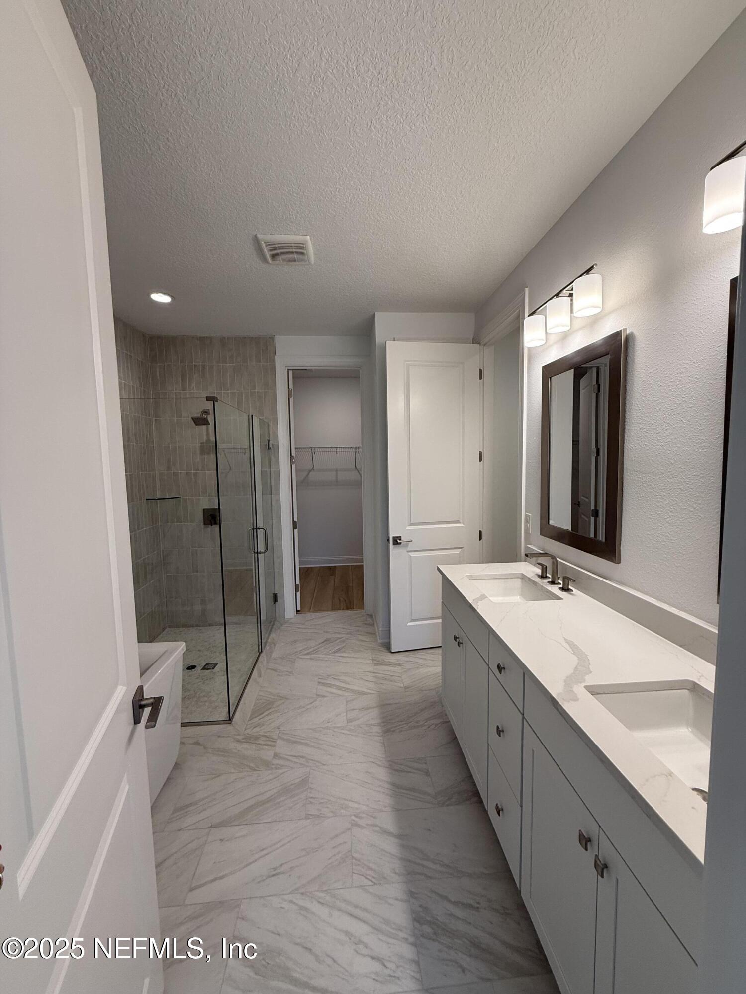 34 Mulberry Road Palm Coast, FL 32164 - Photo 42 of 63 a large bathroom with a granite countertop double vanity sink a mirror and a bathtub