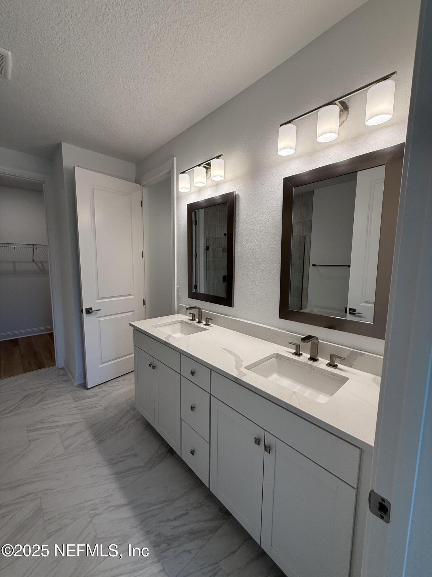 34 Mulberry Road Palm Coast, FL 32164 - Photo 43 of 63 a spacious bathroom with a double vanity sink and mirror