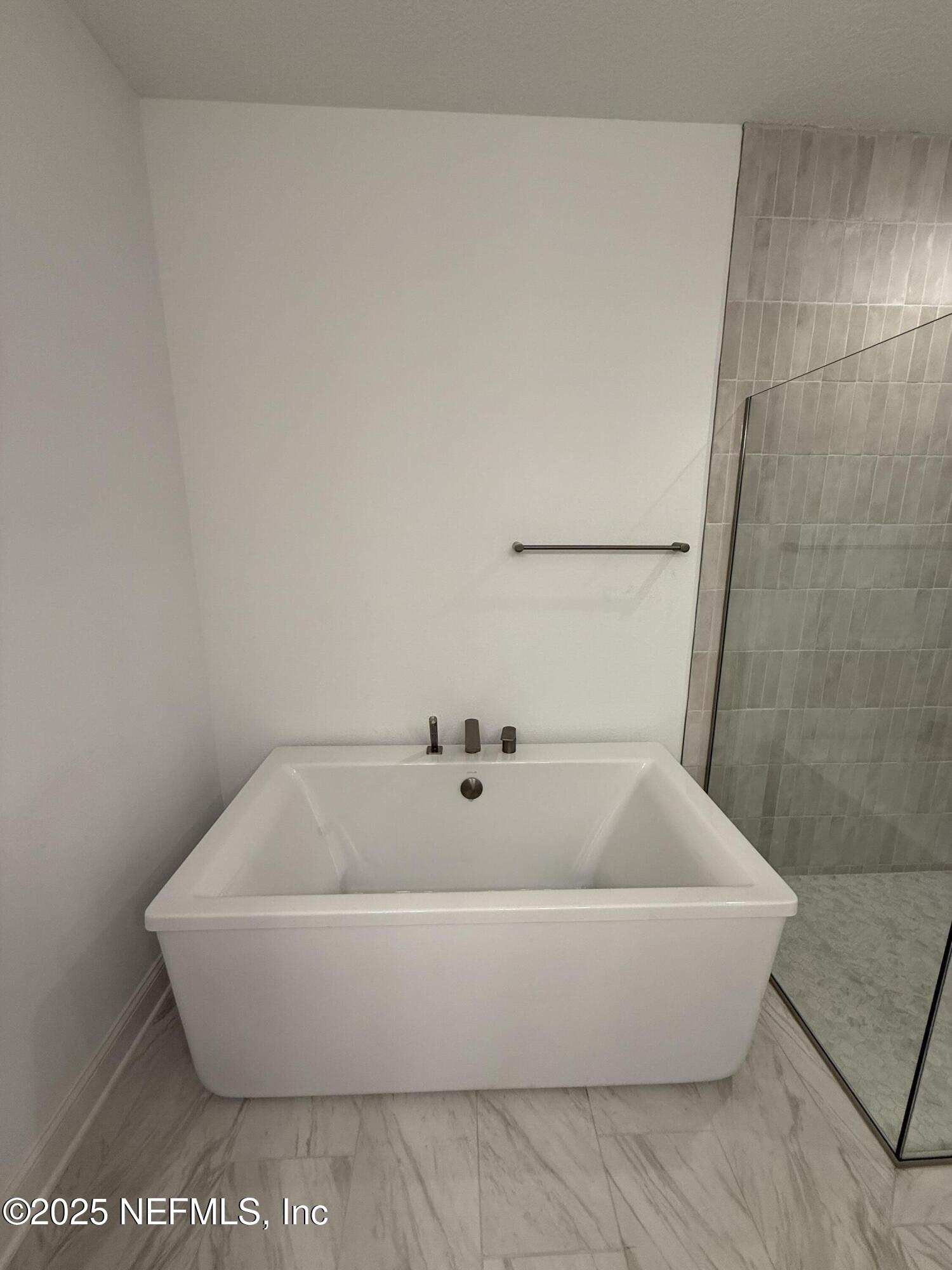 34 Mulberry Road Palm Coast, FL 32164 - Photo 44 of 63 a white tub sitting in a bathroom
