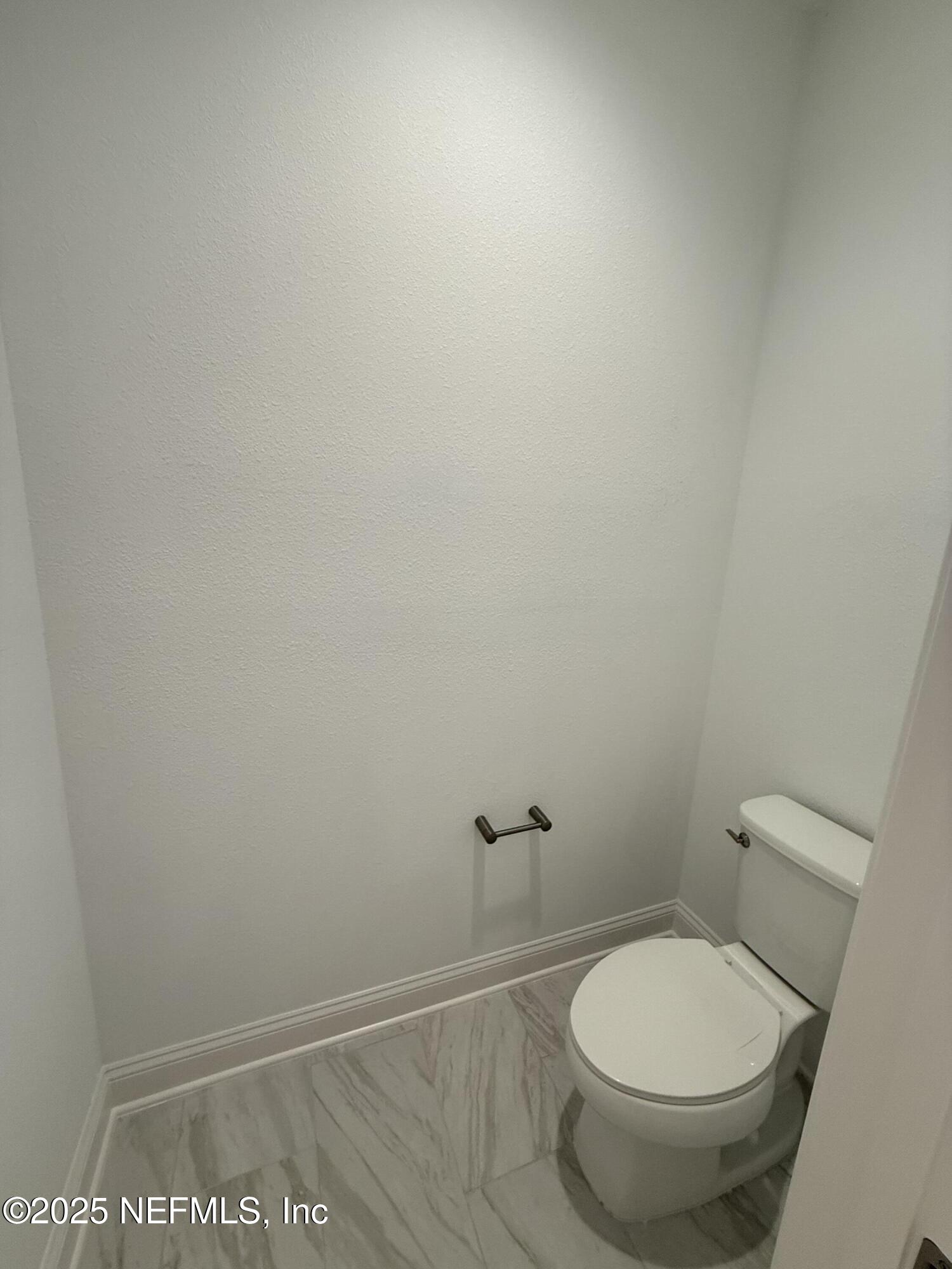 34 Mulberry Road Palm Coast, FL 32164 - Photo 46 of 63 a white toilet sitting next to a shower