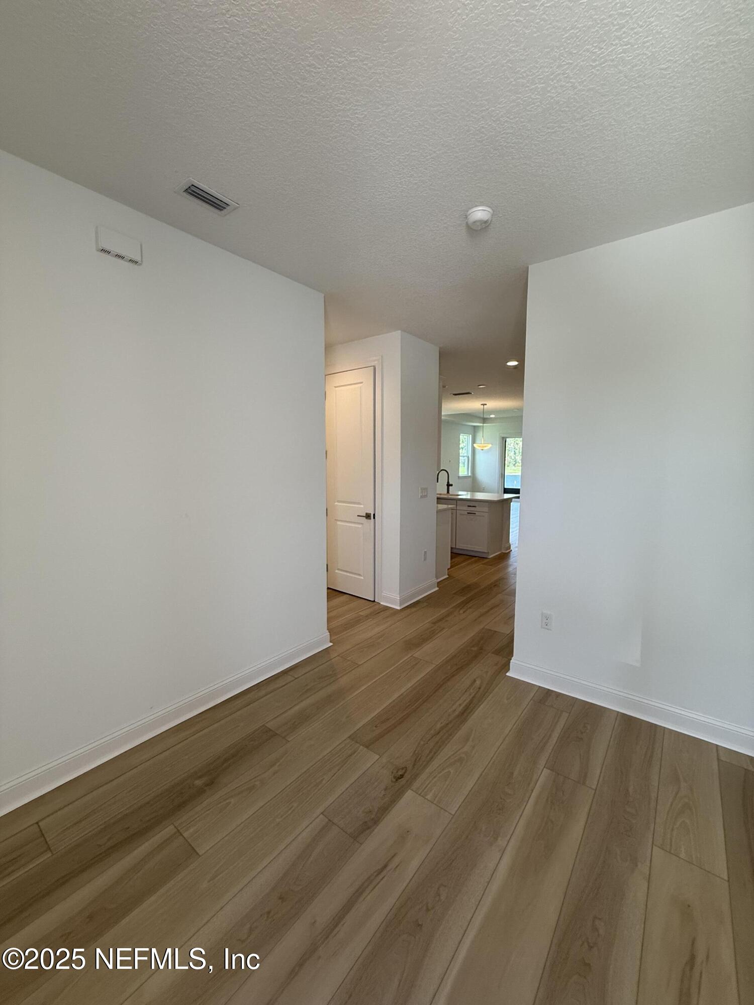 34 Mulberry Road Palm Coast, FL 32164 - Photo 5 of 63 a view of an empty room with wooden floor and windows