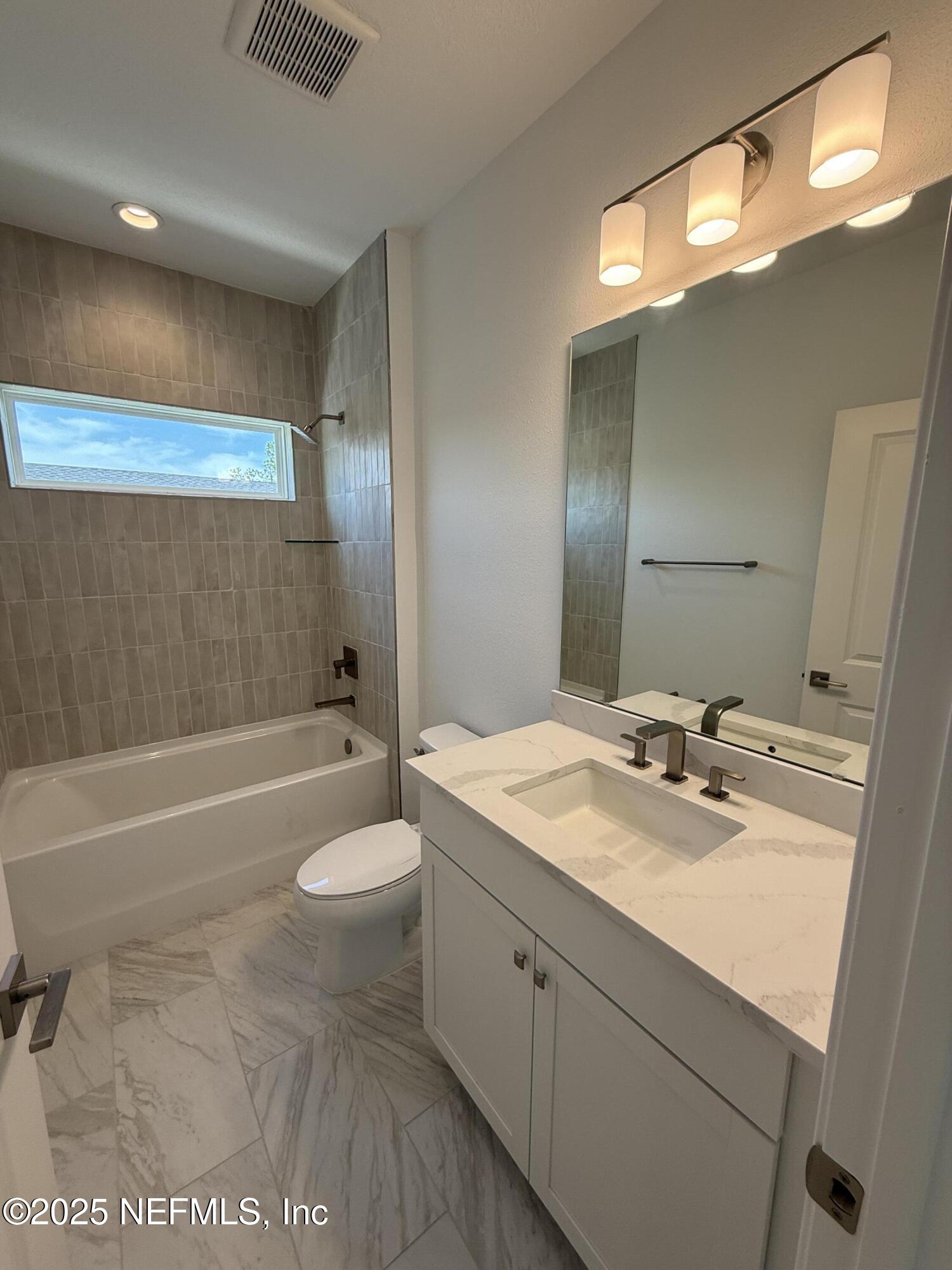 34 Mulberry Road Palm Coast, FL 32164 - Photo 57 of 63 a bathroom with a sink a toilet and shower