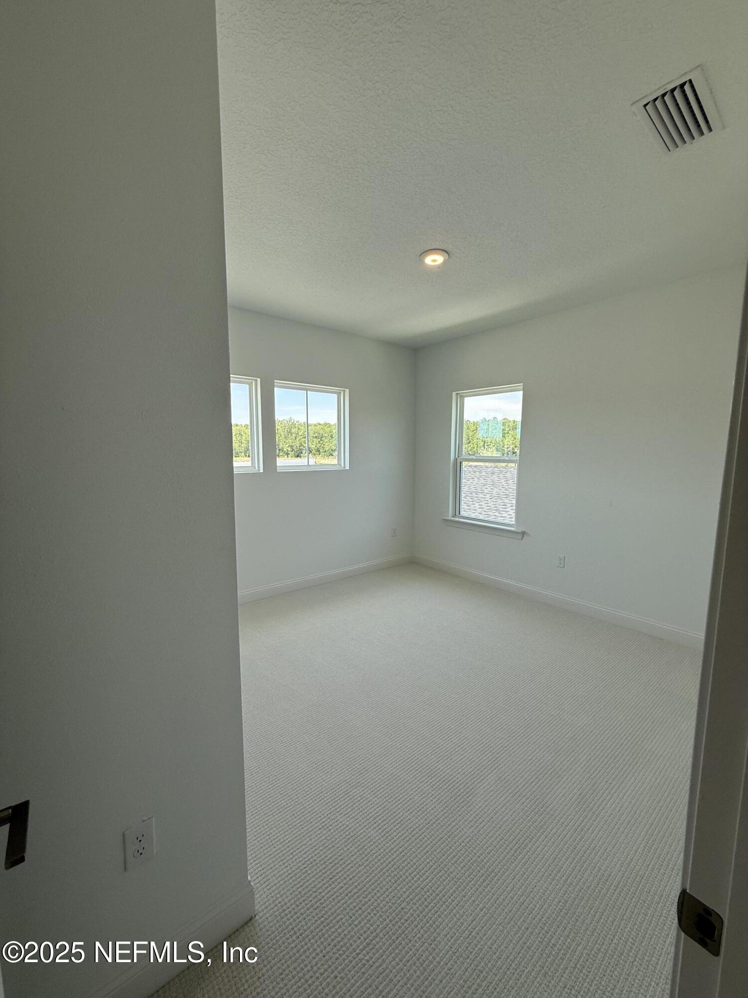 34 Mulberry Road Palm Coast, FL 32164 - Photo 59 of 63 a view of an empty room with a window