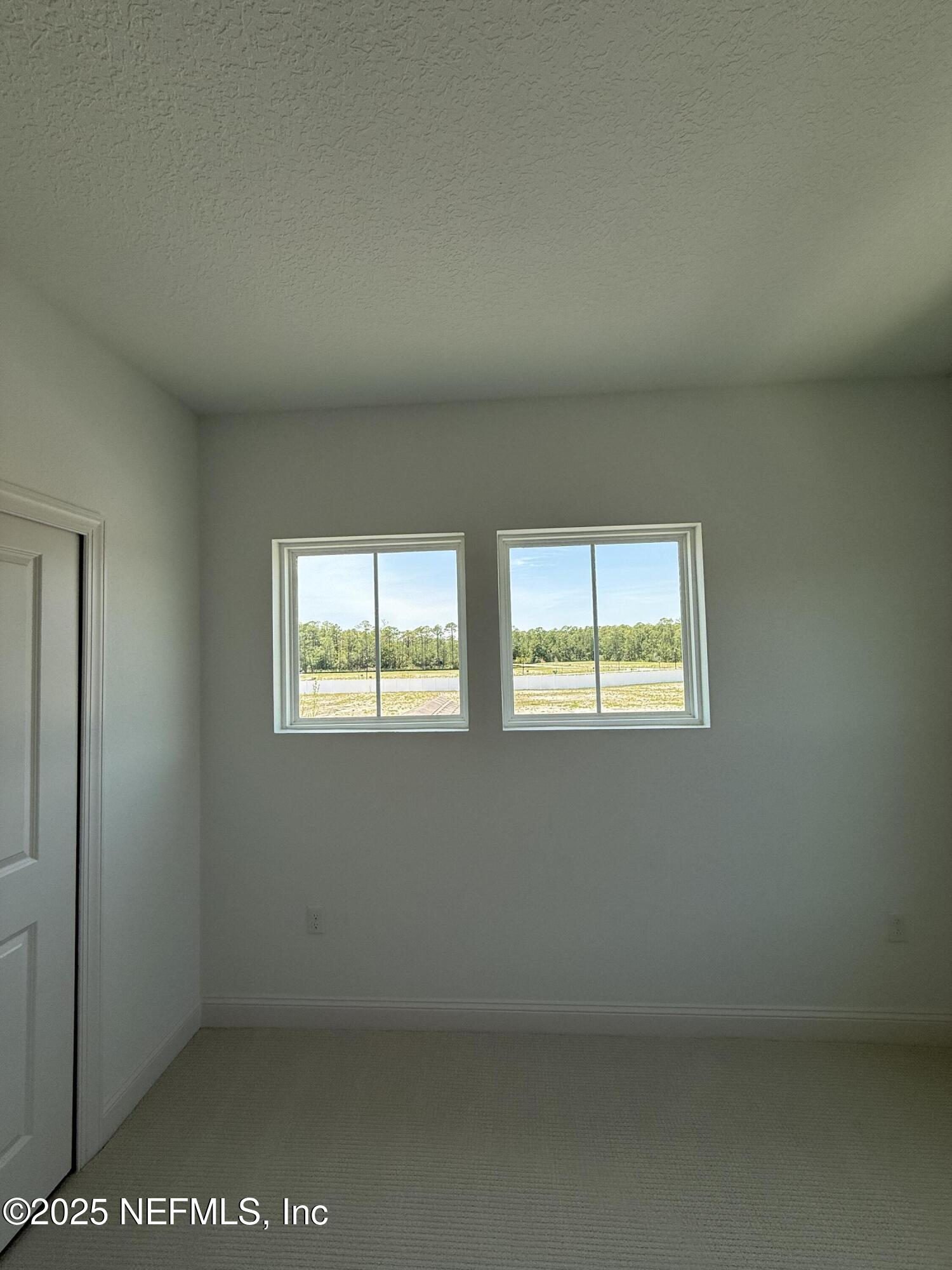 34 Mulberry Road Palm Coast, FL 32164 - Photo 63 of 63 a view of an empty room with two window