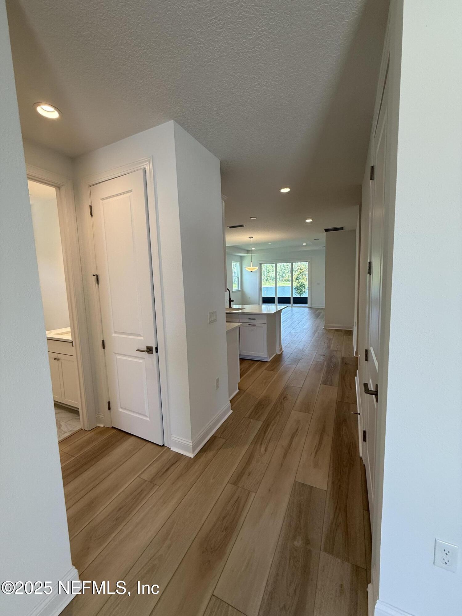 34 Mulberry Road Palm Coast, FL 32164 - Photo 9 of 63 a view of a hallway with wooden floor