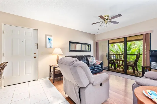 a bedroom with furniture and a large window