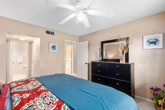 a bedroom with a bed and a mirror on dresser