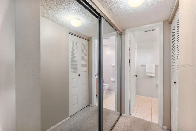 a bathroom with a granite countertop sink toilet and mirror