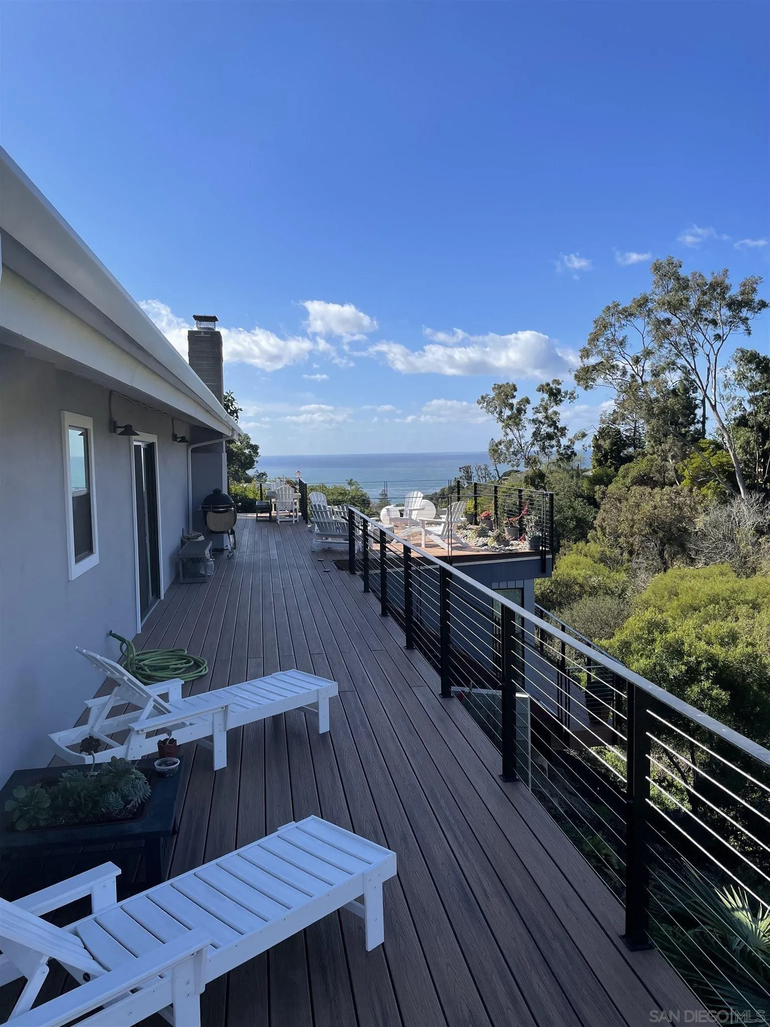 1402 Rodeo Drive La Jolla, CA 92037 - Photo 15 of 62 a view of a balcony with wooden floor and outdoor seating