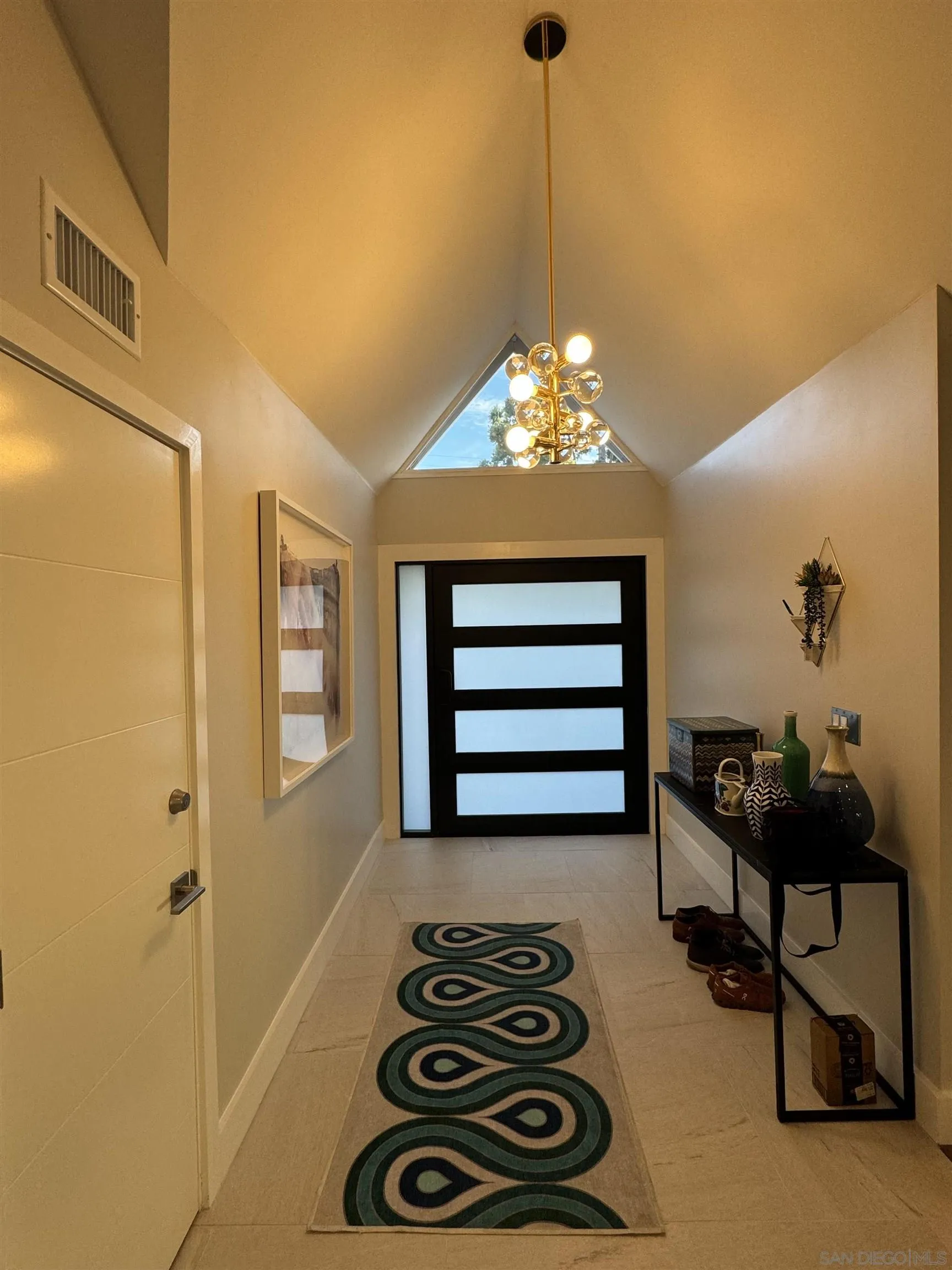 1402 Rodeo Drive La Jolla, CA 92037 - Photo 3 of 62 a bedroom with a bed and a chandelier