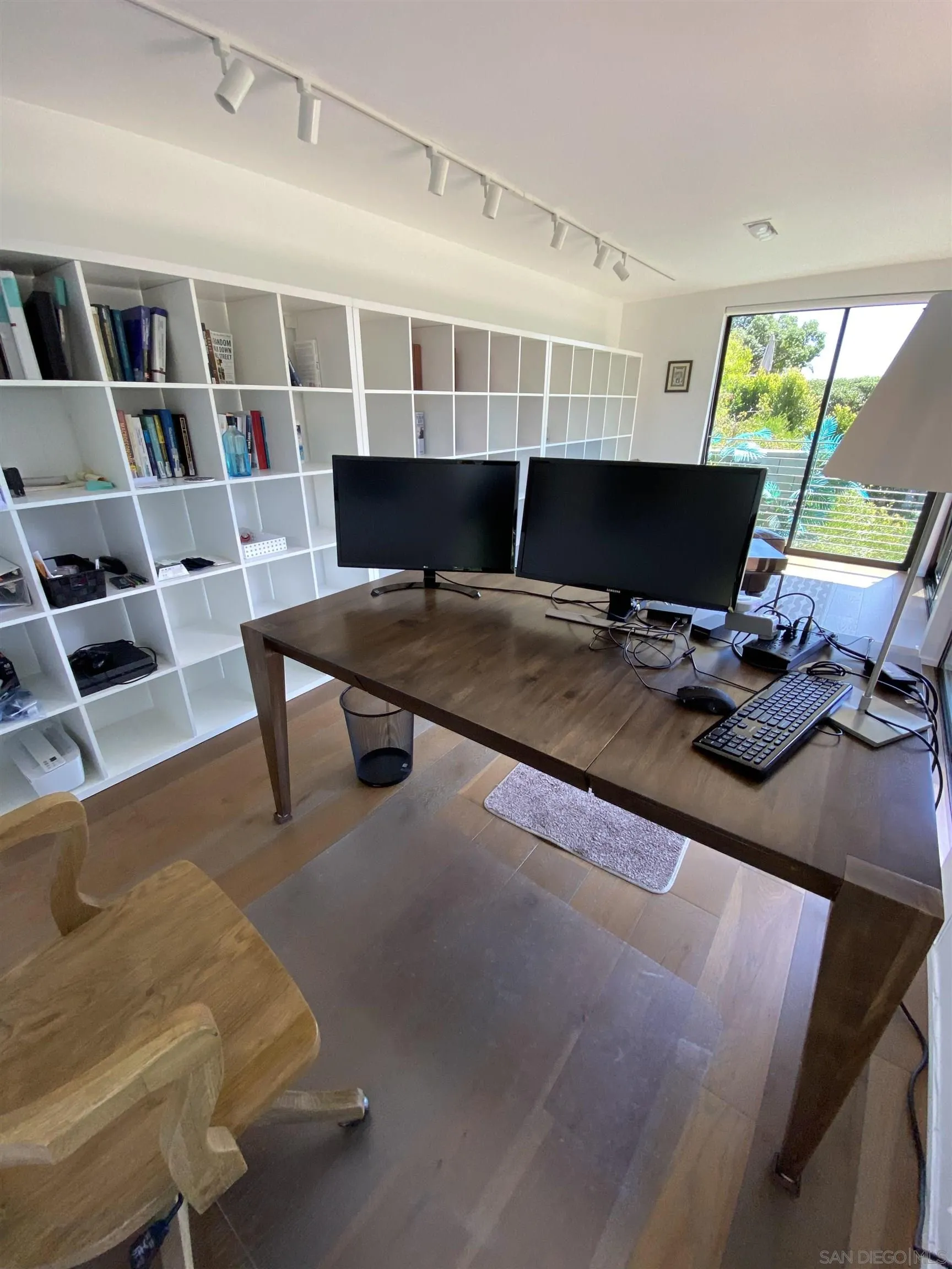 1402 Rodeo Drive La Jolla, CA 92037 - Photo 60 of 62 a living room with furniture and a bookshelf