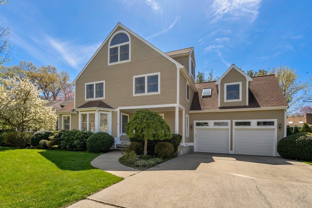 62 Lynn Road Needham, MA 02494 - Photo 1 of 24 a front view of a house with a yard and potted plants