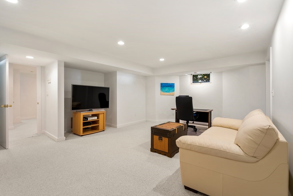 62 Lynn Road Needham, MA 02494 - Photo 17 of 24 a living room with furniture and a flat screen tv
