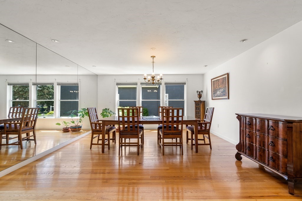 62 Lynn Road Needham, MA 02494 - Photo 4 of 24 a dining room with wooden floor windows and a chandelier
