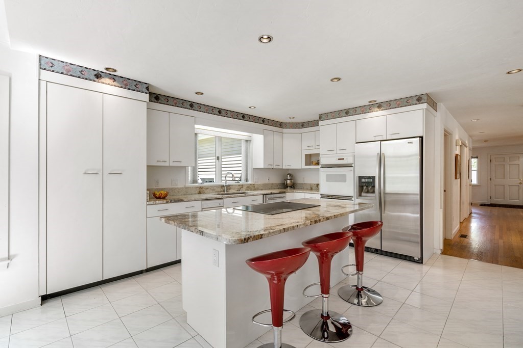 62 Lynn Road Needham, MA 02494 - Photo 7 of 24 a kitchen with refrigerator and cabinets