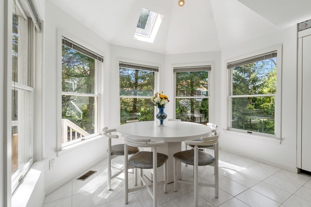 62 Lynn Road Needham, MA 02494 - Photo 9 of 24 a dining room with furniture large windows and a chandelier