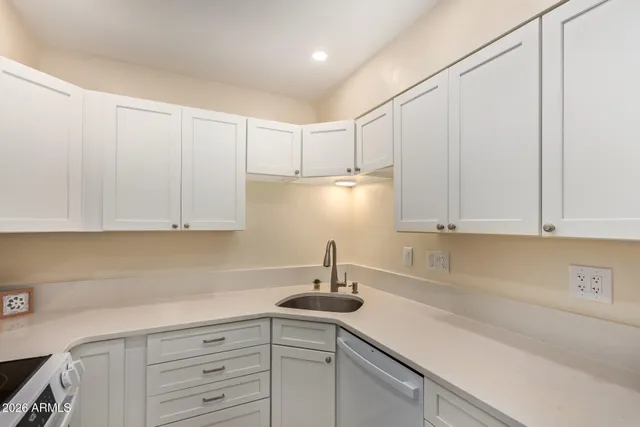 a kitchen with a sink cabinets and window