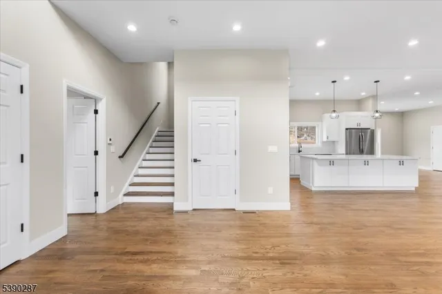 a large kitchen with stainless steel appliances kitchen island granite countertop a stove a sink and a refrigerator