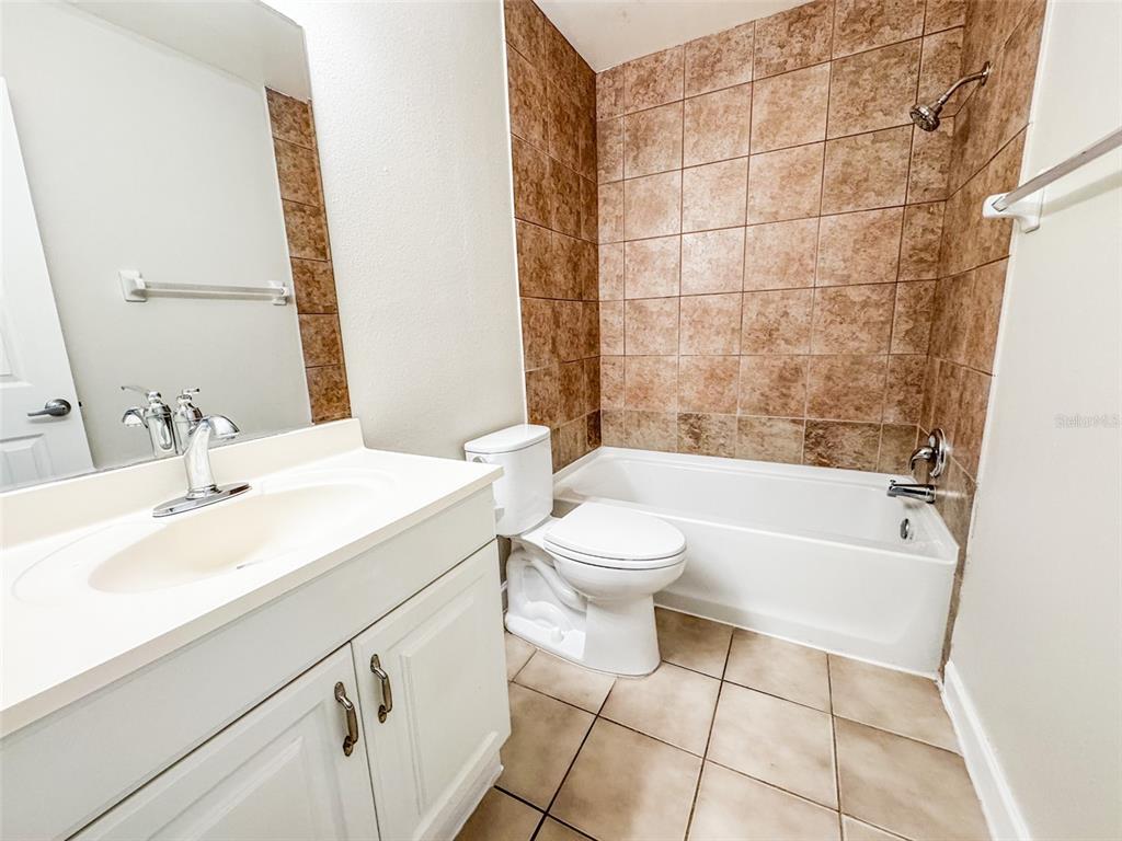 2732C Hidden Lake Boulevard, Unit D Sarasota, FL 34237 - Photo 11 of 19 a bathroom with a sink a toilet and bathtub