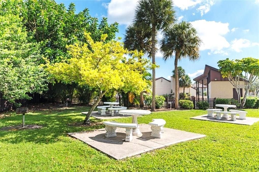 2732C Hidden Lake Boulevard, Unit D Sarasota, FL 34237 - Photo 17 of 19 a view of a swimming pool with a table and chairs