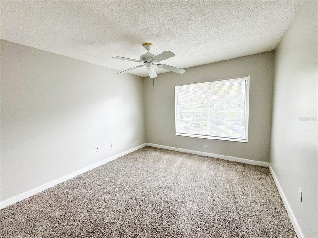 2732C Hidden Lake Boulevard, Unit D Sarasota, FL 34237 - Photo 10 of 19 an empty room with a window and a ceiling fan