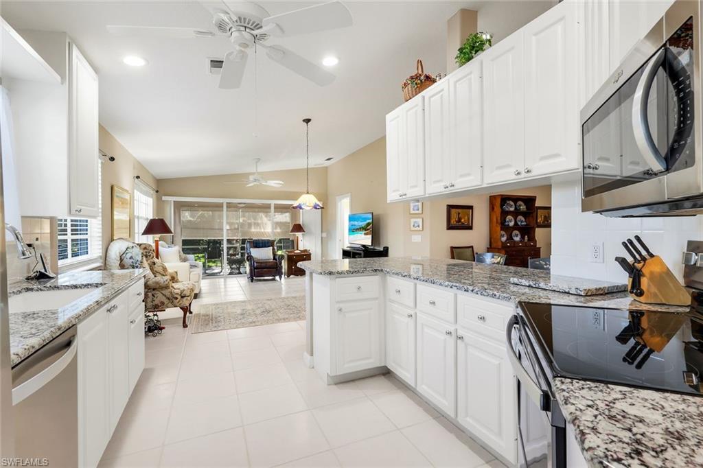 3333 Cayman Lane Naples, FL 34119 - Photo 17 of 43 a large white kitchen with lots of counter top space